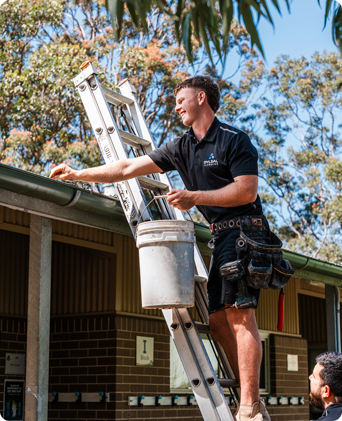 DYLSAL plumber jet-blasting gutters for thorough cleaning
